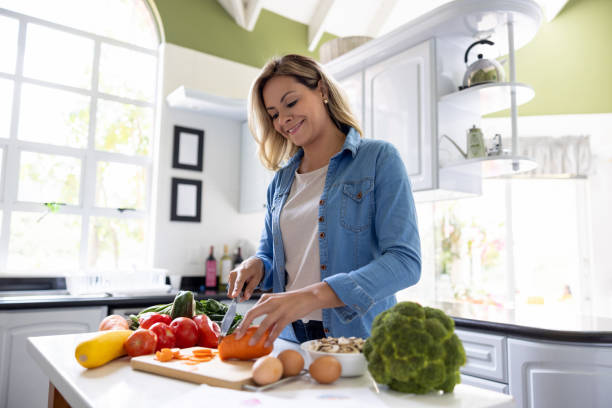istock Happy woman cooking at home 1497209444