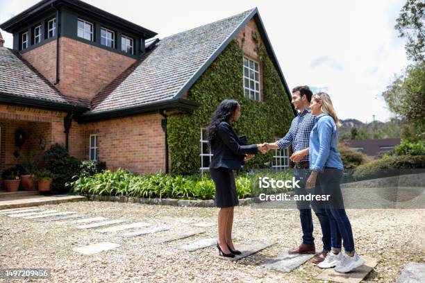 Real Estate Agent Meeting A Couple For A House Showing Stock Photo - Download Image Now
