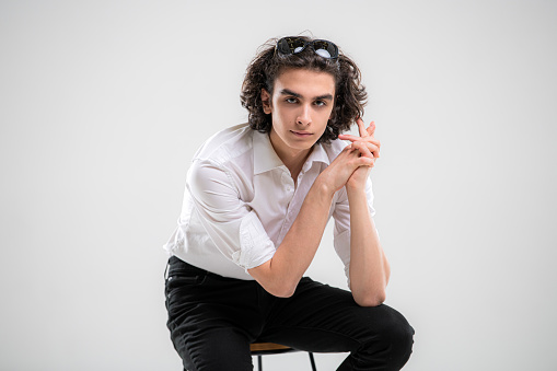 portrait of a handsome young man model in white shirt on a white background.