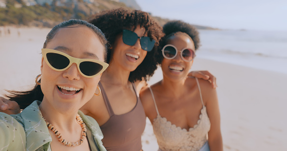 Women friends, beach and selfie on vacation or picnic while happy with sunglasses. Diversity girl group having fun in summer happy about social media influencer content