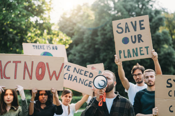 istock A group of climate activists are marching together holding signs 1497210877