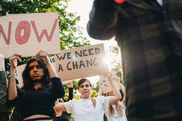istock A group of climate activists are marching together holding signs 1497210883