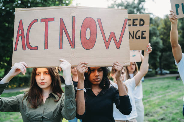istock A group of climate activists are marching together holding signs 1497210894
