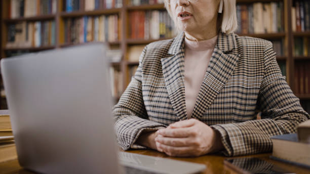 istock Experienced professor conducting an online lecture, distance education, via video call 1497213185