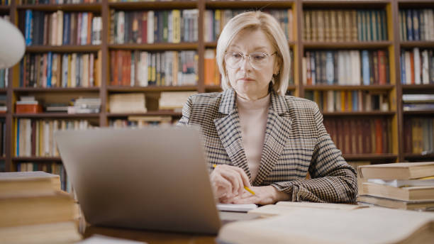 istock Professor conducting online classes, education during the pandemic, via video call 1497213304