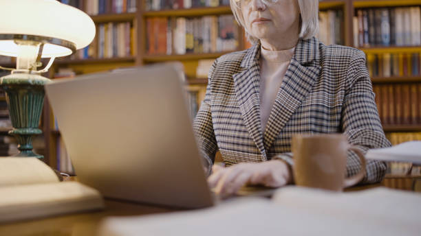 istock Overworked journalist writing a new article on her laptop, working late, a remote worker 1497213961
