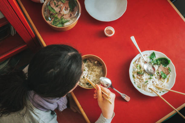 istock overhead view on girl eating pho soup from delivery service 1497217211