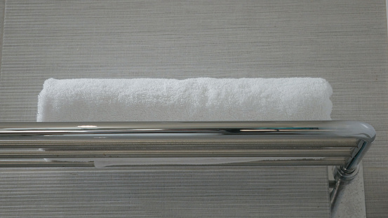 Towel on a shelf, in the bathroom of hotel. Surabaya, East Java, Indonesia. December 27, 2022