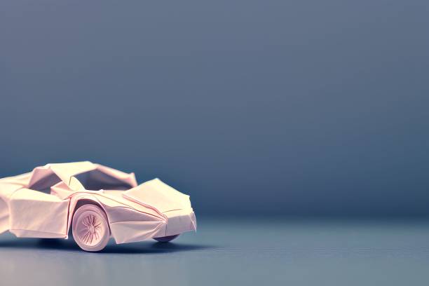 istock Vibrant pink origami-style car with sleek black wheels sits atop a solid blue background 1497217702