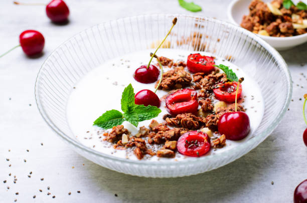 Yogurt with Cherries, Granola and Chia Seeds over Bright Background