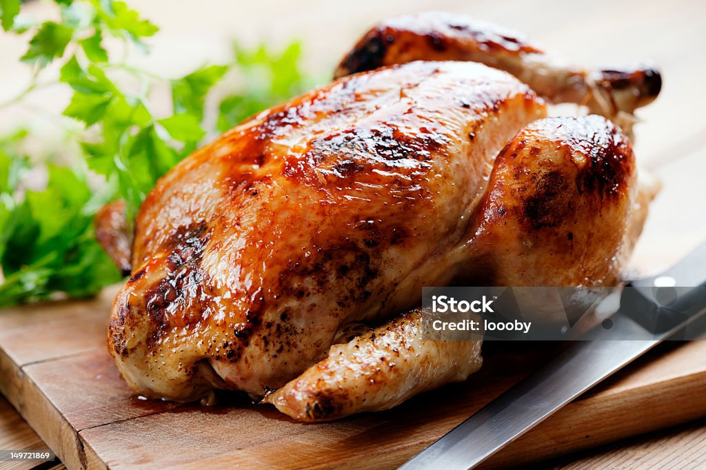 Full roast chicken on wood cutboard whole roasted chicken Chicken Meat Stock Photo