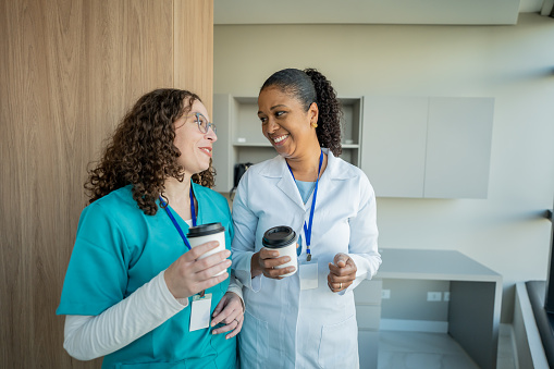 Female doctor and nurse having coffee break