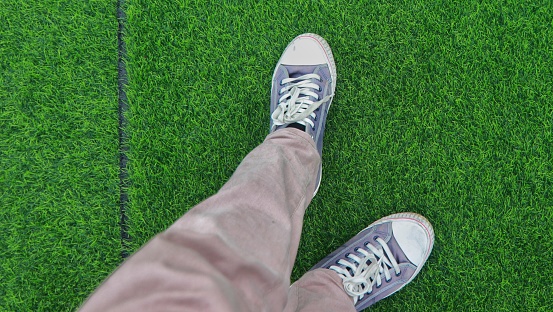 Navy sneakers on the grass