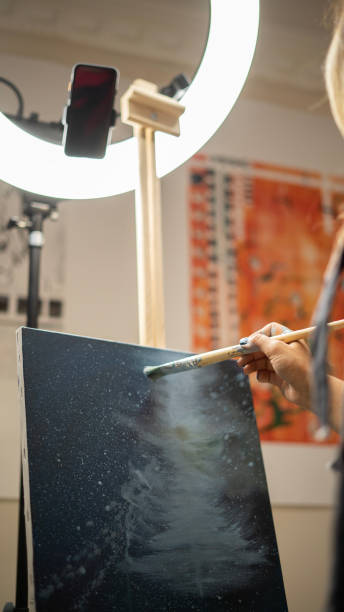 istock Close-up Artist woman paints on canvas in workshop 1497232465