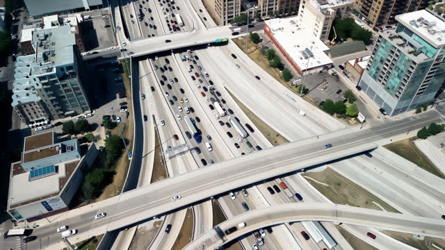 Overhead drone footage of cars driving over elevated highway and busy interchange in Chicago