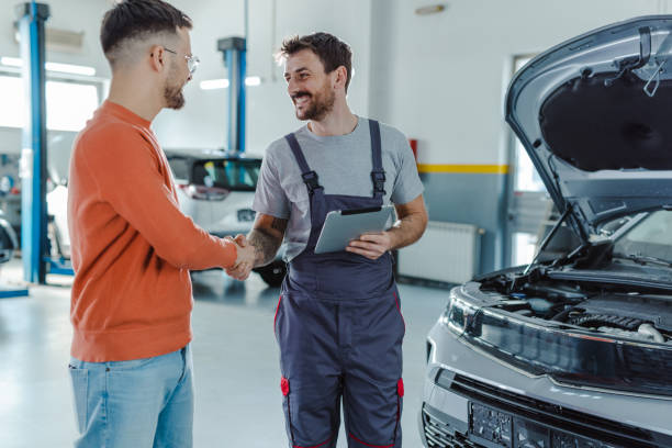 istock Young man shaking hands with car mechanic 1497239621