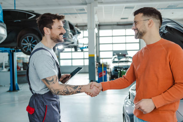istock Young man shaking hands with car mechanic 1497239687