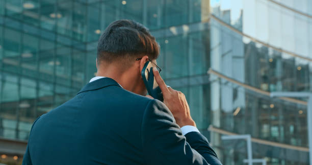 istock Phone call, back and business man walking in city, chatting or conversation outdoors. Technology, 5g smartphone and male employee with mobile cellphone for networking, talking or discussion in town. 1497243415