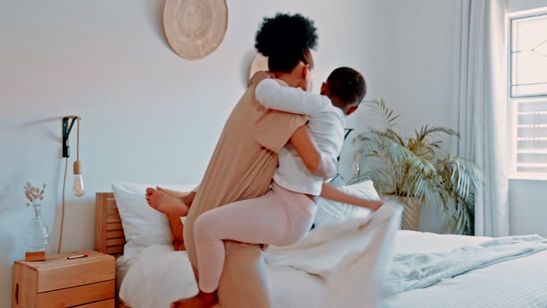 Mother carrying her child to bed in their home with love, care and happiness for a afternoon nap. Loving, family and African woman taking her girl kid to rest in her bedroom in their modern house.