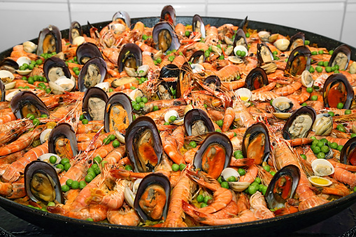 Paella, classic dish of Spanish gastronomy with seafood, meat, chicken and saffron rice