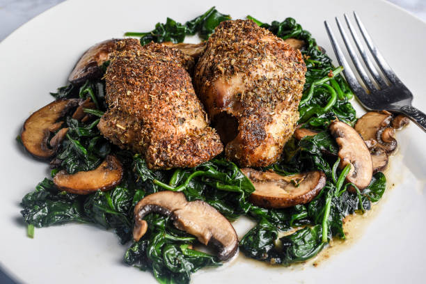 istock bone less chicken thighs  on sauteed spinach and  mushrooms 1497248105