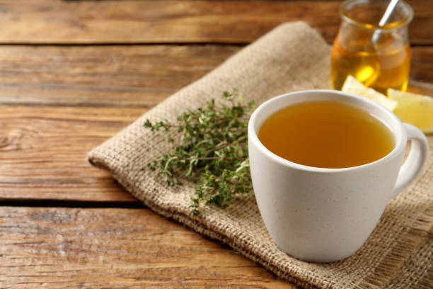 istock Aromatic herbal tea with thyme on wooden table, space for text 1497249692