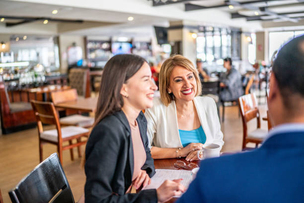 istock Happy coworkers talking on a coffee break at a coffee shop 1497250969