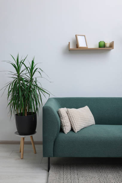 istock Comfortable sofa with soft cushions in light room. Interior design 1497251834