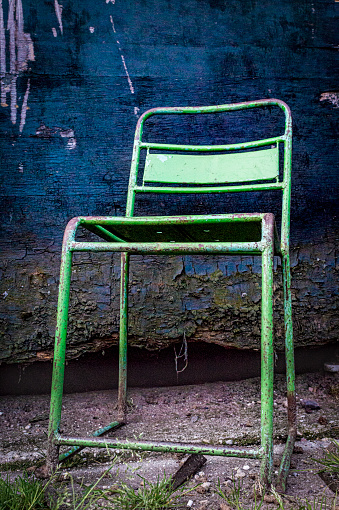 Vintage Metal Chair against a Decaying Background