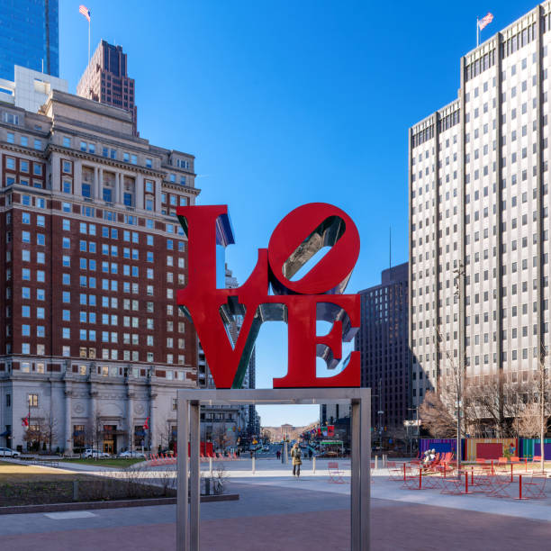 I love Philly sign at Love Park in Philadelphia during summer day.\nFountain and City Hall in background.