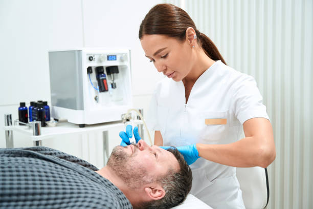 istock Woman cosmetologist uses a non-surgical microdermabrasion method in her work 1497255781