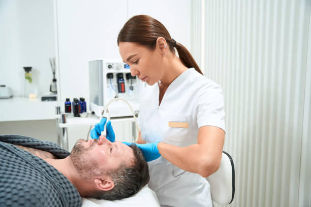 istock Experienced cosmetologist uses the non-surgical microdermabrasion method 1497256178