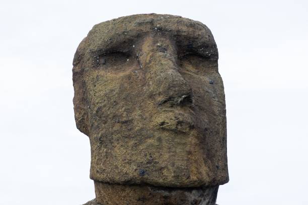 istock Isolated Moai Monument Stone Statue Face Close Up Vertical Portrait Front View on White Background 1497256693