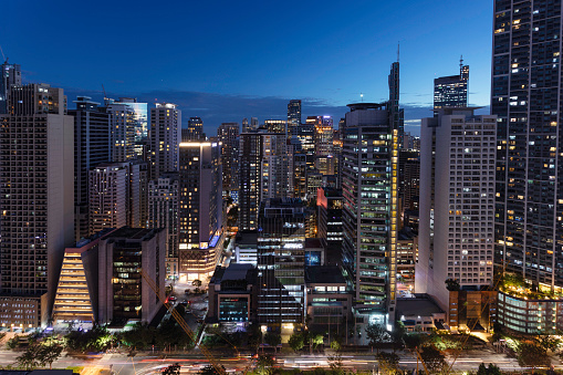 Night view of a cityscape with apartment and office buildings in Bel-Air in Makati, Metro Manila, Philippines.