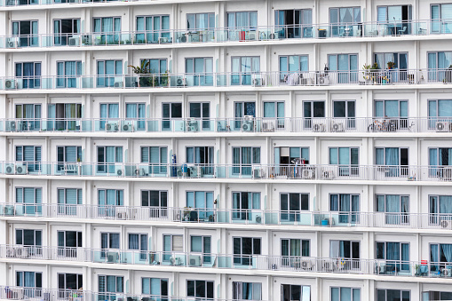 Close up of a modern condominium skyscraper facade in Makati, Philippines.