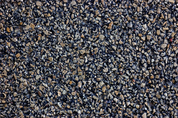 Old aged weathered dark grey black tarmac texture pattern, large detailed wet textured asphalt grungy background flat lay, horizontal rough grained pattern macro closeup, grunge copy space