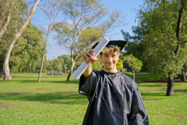 istock Young recent graduate boy showing off his degree 1497258697