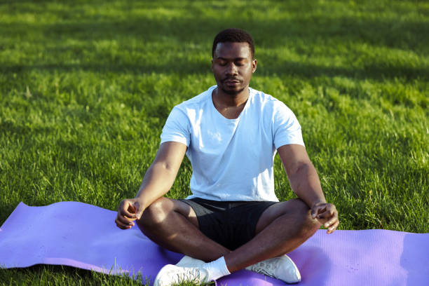 istock African American man meditating in park 1497261757