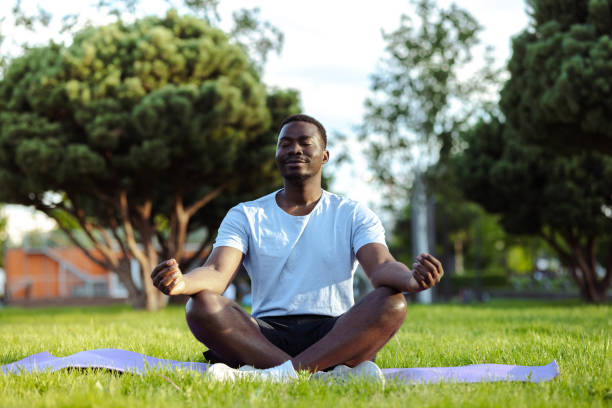 istock African American man meditating in park 1497261779