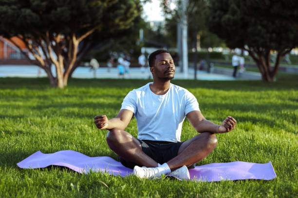 istock African American man meditating in park 1497261965