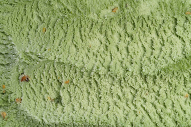 natural pistachio ice cream closeup background, shallow focus