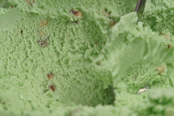 istock scooping natural pistachio ice cream with spoon closeup 1497262802