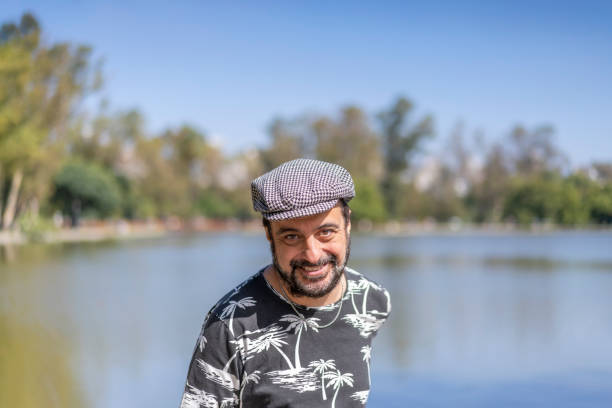 istock Bearded mature man wearing a beret at a lake. Copy space 1497262847