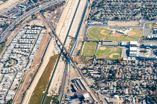 South Gate, California, USA - Aerial view of the Old South Gate Train bridge, The Los Angeles River, Legacy High School and suburban South Gate, California