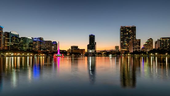 Orlando city skyline at night. Panoramic view of Orlando in Lake Eola Park, Florida, USA.