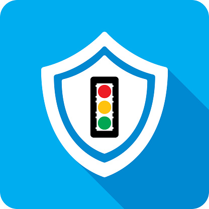 Vector illustration of a shield with traffic light icon against a blue background in flat style.