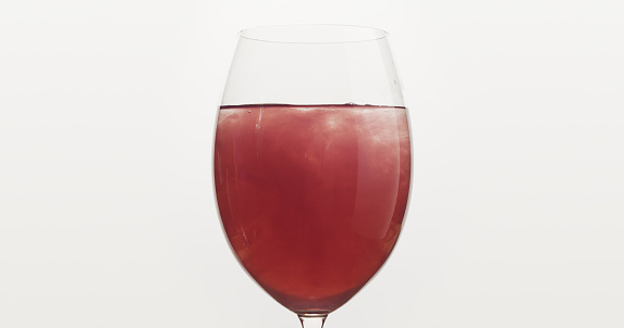 pour blueberry juice into water in wine glass, wide photo