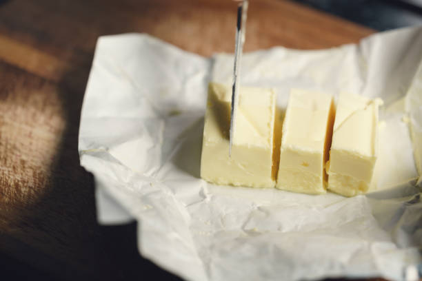 istock slicing butter brick with knife 1497267331