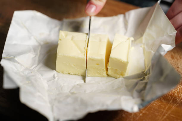 istock slicing butter brick with knife 1497267523