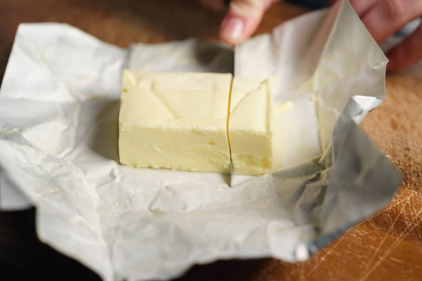 istock slicing butter brick with knife 1497267576